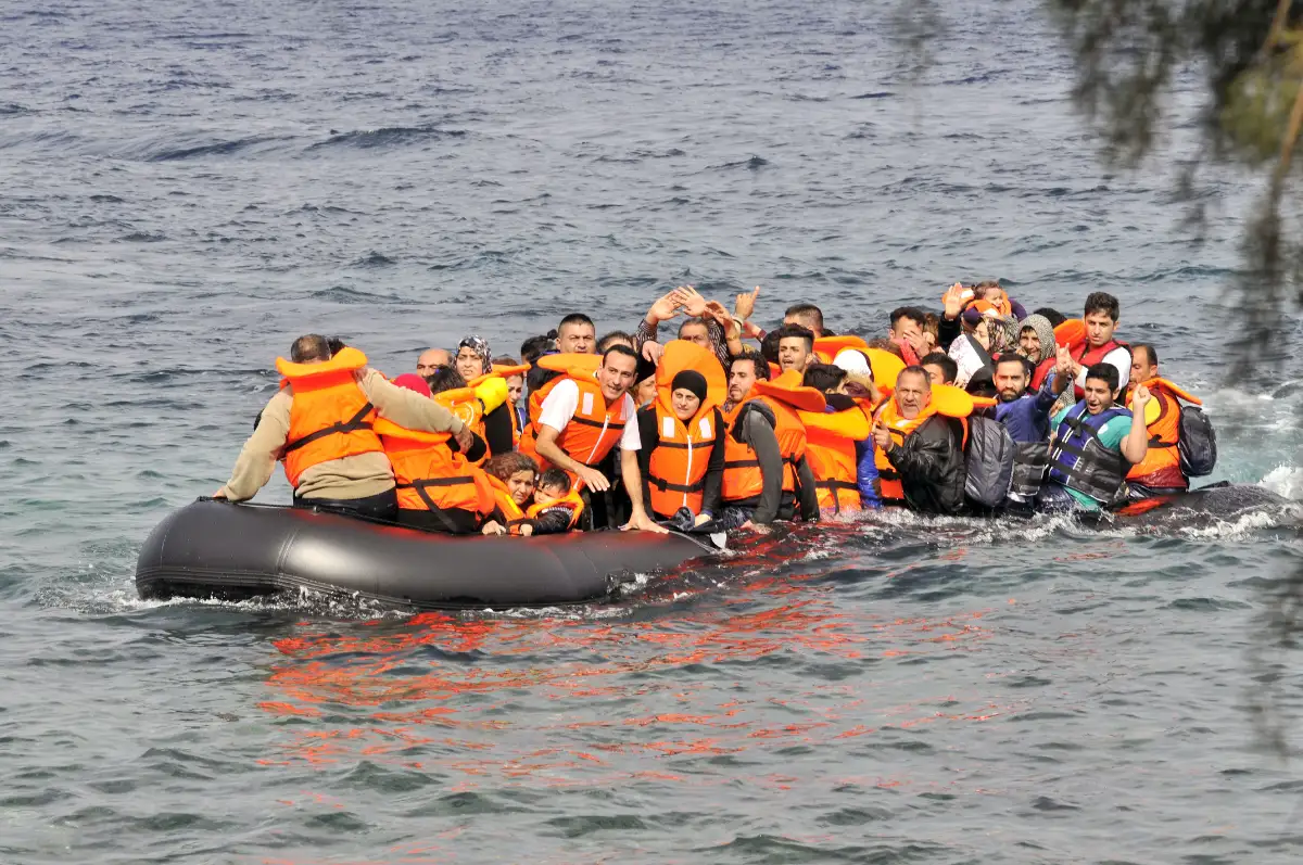 refugees in a boat sinking